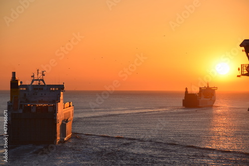 Bright sunset over ships at sea