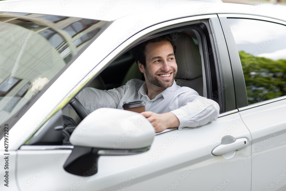 Happy businessman driving car while drinking coffee takeaway, good morning and road to office Happy businessman driving car while drinking coffee takeaway, good morning and road to office
