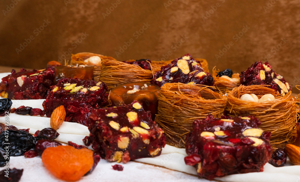 Dried fruits baklava and Turkish delight with pistachios and nuts, close-up view .