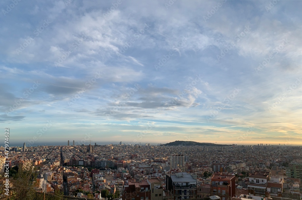 View of Barcelona city skyline from Mirador de les bateries. Sagrada de Familia and other famous sightseeing objects in the background. Aerial, panoramic, scenic view. Barcelona, Catalonia, Spain