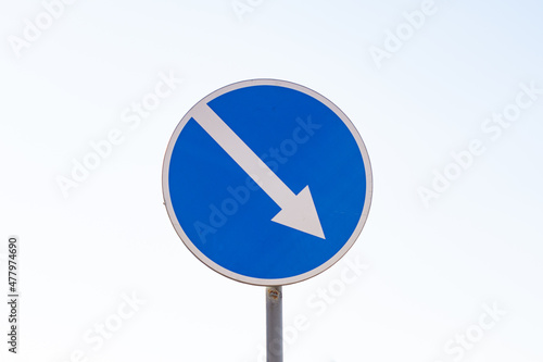 Blue arrow sign pointing the way