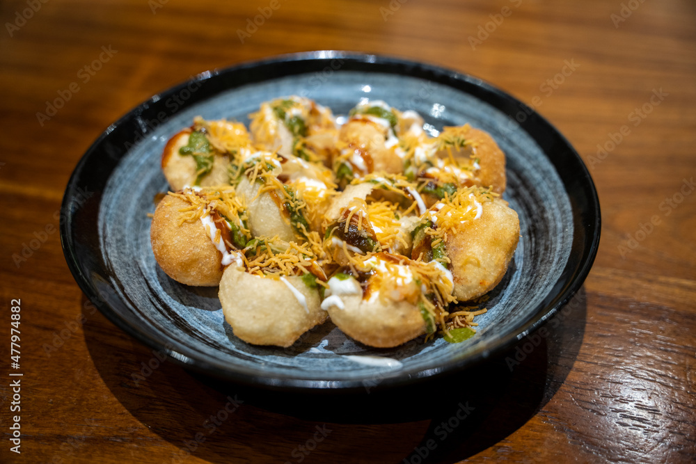 A plate with ready to eat panu puri or golgappa, Indian streetfood snack A plate with ready to eat panu puri or golgappa, Indian streetfood snack
