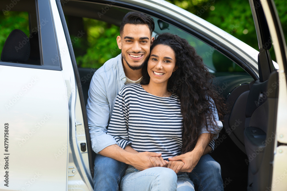 Beautiful middle-eastern lovers enjoying car trip to countryside Beautiful middle-eastern lovers enjoying car trip to countryside
