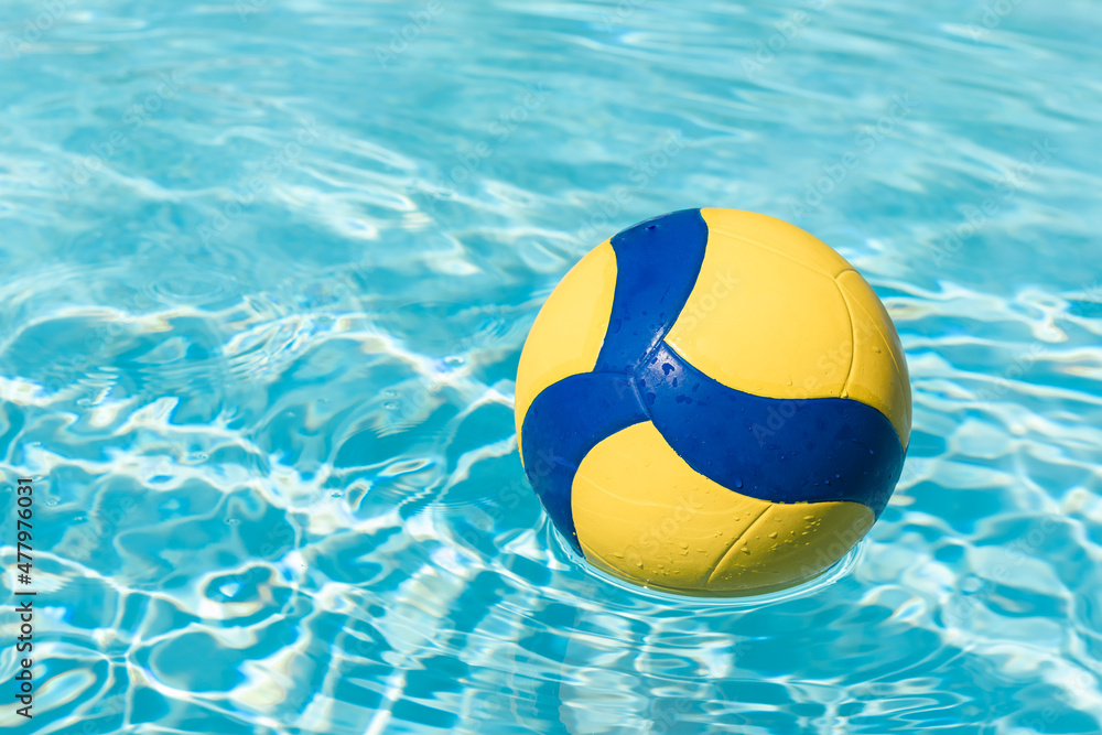 Sports ball on the surface of swimming pool's water, water volleyball.