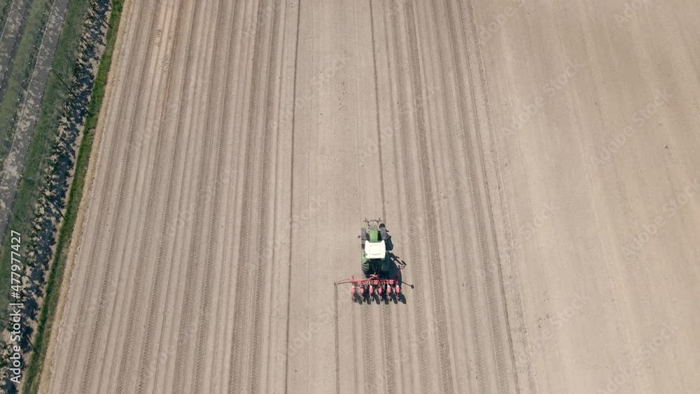 Video of aerial view of tractor cultivating field Video of aerial view of tractor cultivating field
