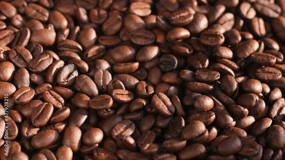 Close up of seeds of coffee. Fragrant coffee beans are rotate Close up of seeds of coffee. Fragrant coffee beans are rotate