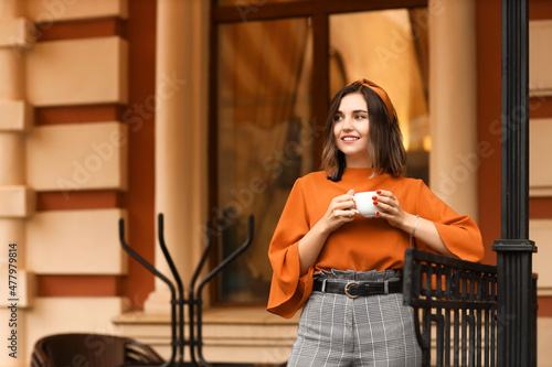 Fashionable woman with cup ...