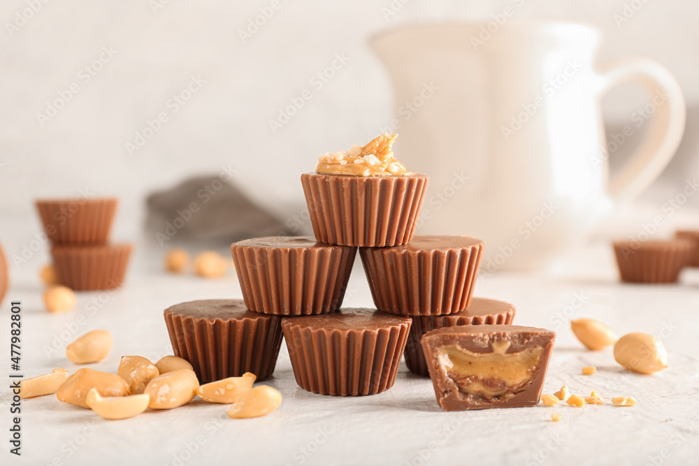 Tasty peanut butter cups on light background Tasty peanut butter cups on light background