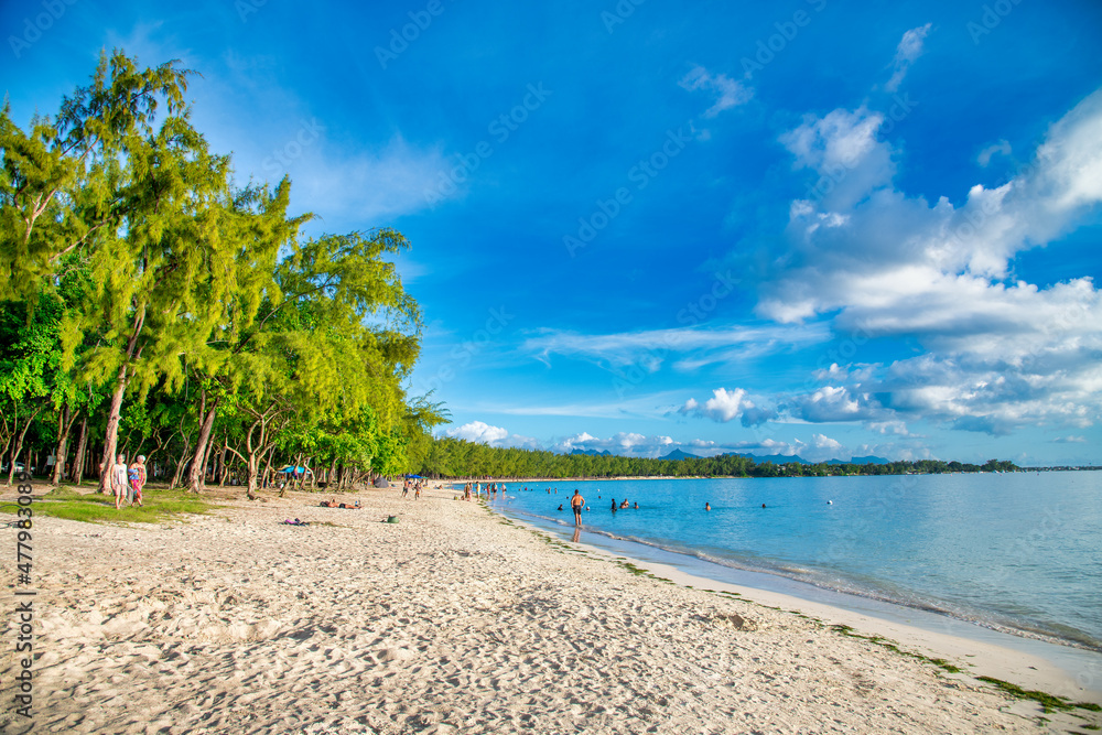 MAURITIUS - APRIL 24, 2019: Tourists and locals along a famous beach.