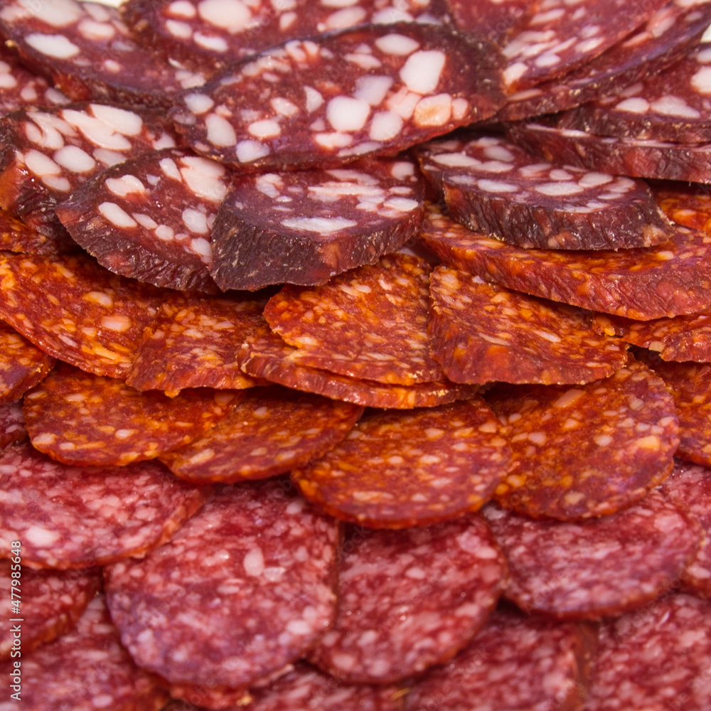 Large group of thinly sliced sausages on a plate Large group of thinly sliced sausages on a plate