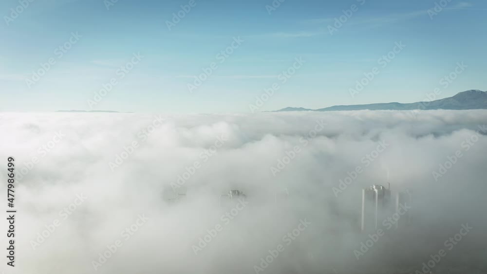 Aerial shot of skyscrapers in the fog city by the sea Aerial shot of skyscrapers in the fog city by the sea