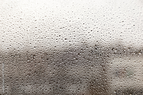 Raindrops on glass on a blurred background. Rain on the window. Texture. Photo