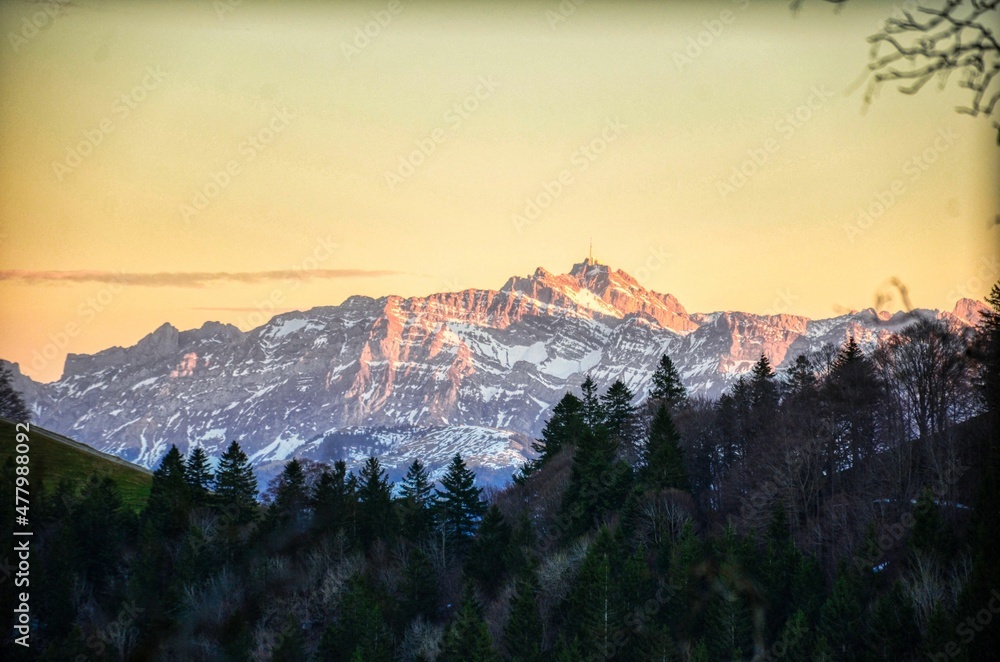 dramatic view of the santis in alpstein appenzell. The summit shines in the last rays of the sun. Snow in the Alps