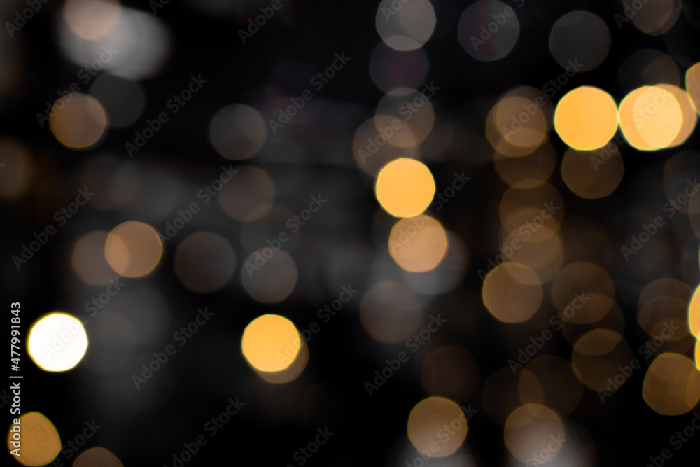 Defocused bokeh lights on black background, an abstract naturally blurred backdrop for Christmas eve or birthday party. Festive light texture. Yellow and red garland in blur. Overlay effect for design Defocused bokeh lights on black background, an abstract naturally blurred backdrop for Christmas eve or birthday party. Festive light texture. Yellow and red garland in blur. Overlay effect for design