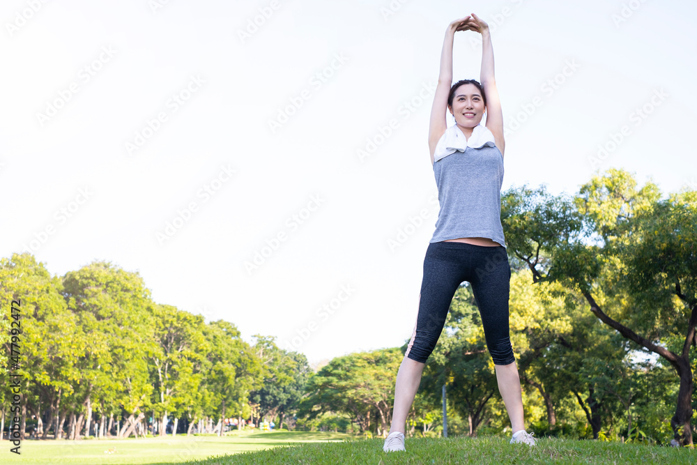 She is stretching. Young female warmup before training session at the park. Healthy young woman warming up outdoors. Female runner stretching before running at morning. Young woman training in park. She is stretching. Young female warmup before training session at the park. Healthy young woman warming up outdoors. Female runner stretching before running at morning. Young woman training in park.