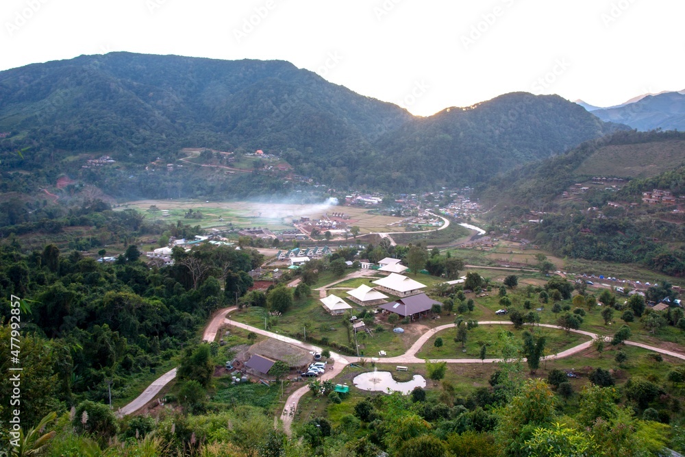 Aerial view of Sapun Village at sunrise in the valley of mountains with misty mountain range