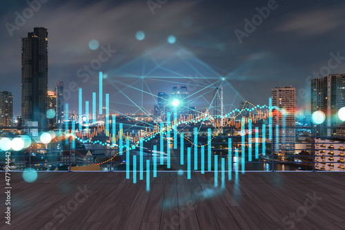 Rooftop with wooden terrace, Bangkok night skyline. Forecasting and business modeling of financial markets hologram digital charts. City downtown. Double exposure.