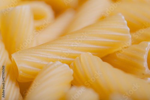 close up raw italian durum wheat pasta tortiglioni background top view