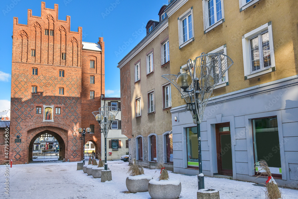 Gate and tenement houses in the old town. Olsztyn in Poland.