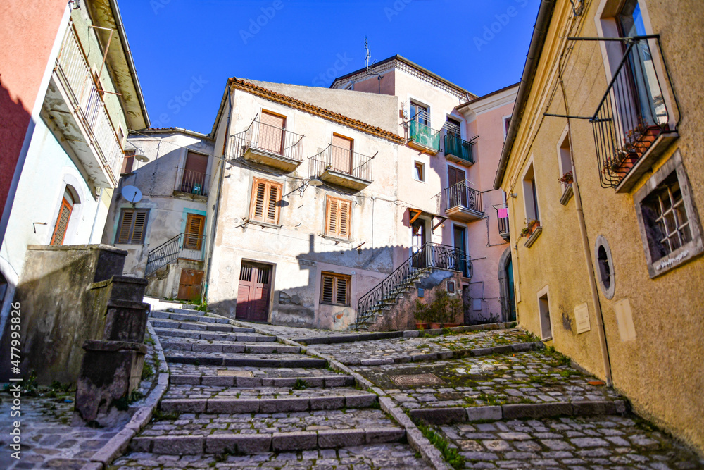 A small street between the old houses of Pignola, a small town in the province of Potenza in Basilicata, Italy.