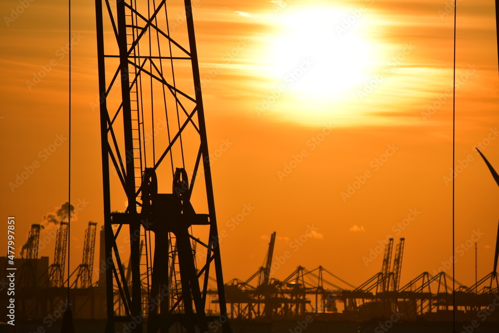 Sunset harbour - including cranes and other port machinery