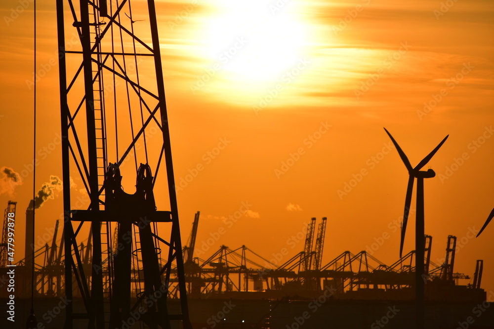 Sunset harbour - including cranes and other port machinery