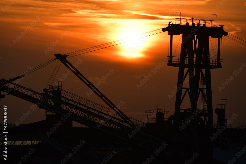 Sunset harbour - including cranes and other port machinery