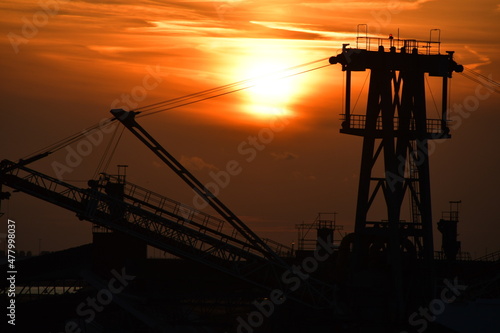 Sunset harbour - including cranes and other port machinery