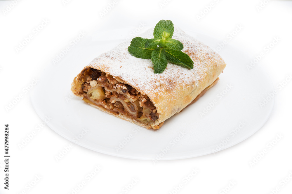 Traditional Viennese strudel with apples and raisins isolated on a white background