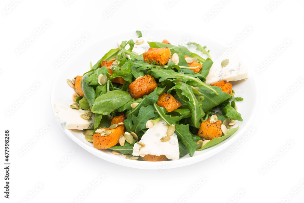 Vegetable salad with pumpkin, arugula and blue cheese on a white background
