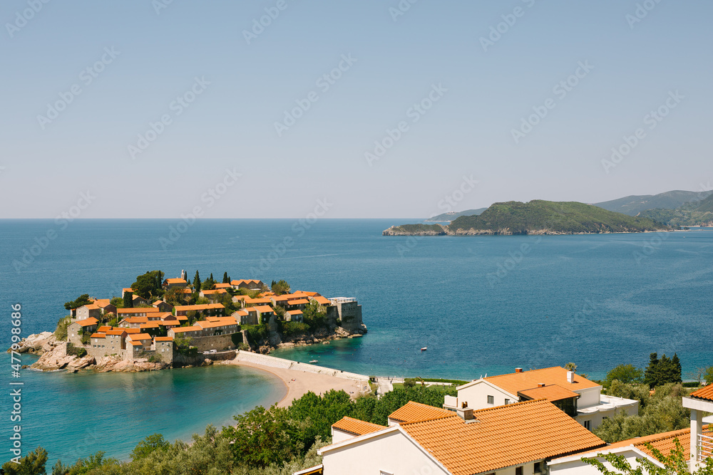 Stone houses with red roofs on the island of Sveti Stefan in the Bay of Kotor