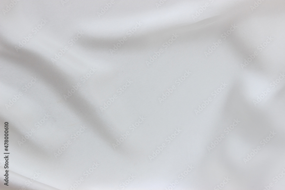 White silk waving fabric background. Abstract smooth elegant texture for design.