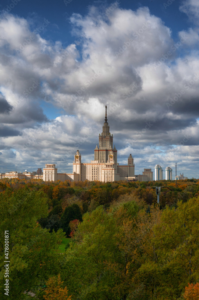 The high-rise of Moscow University main building. Summer sunlight in the blue sky with clouds. One of Stalinist skyscrapers. The high-rise of Moscow University main building. Summer sunlight in the blue sky with clouds. One of Stalinist skyscrapers.