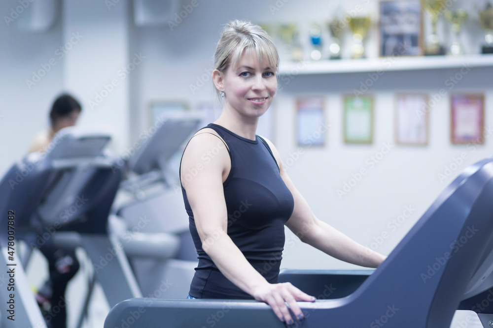 A woman works out in the gym.Fitness classes in the gym. A woman works out in the gym.Fitness classes in the gym.