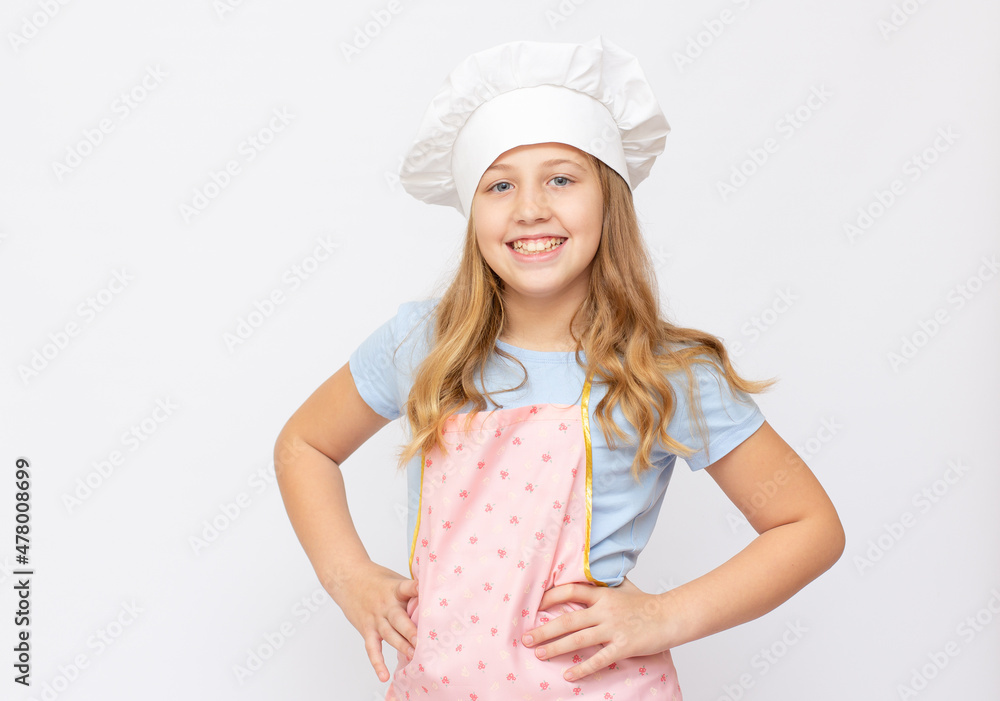 Beautiful little girl in chef uniform isolated on white copy space banner Beautiful little girl in chef uniform isolated on white copy space banner
