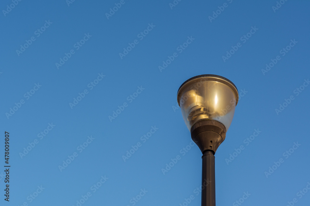 Street lantern, electric lighting. Lamp on background of blue sky. Street lantern, electric lighting. Lamp on background of blue sky.