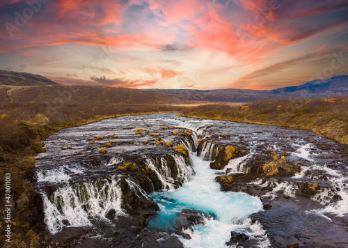 Colorful sunset at the Bruarfoss waterfall in south Iceland with blue water