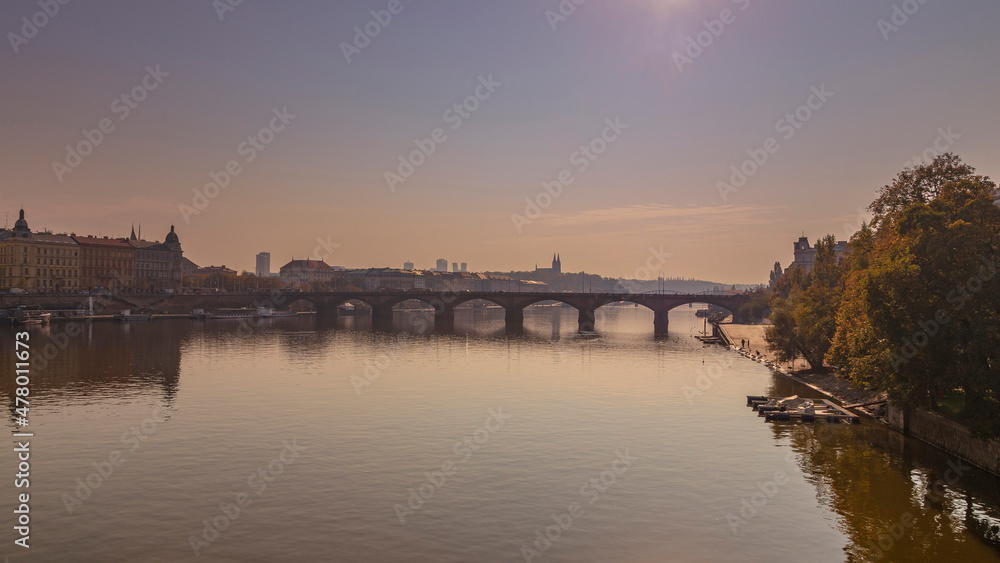 River Vltava with bridges and a boat on the surface in the city of Prague in the Czech Republic