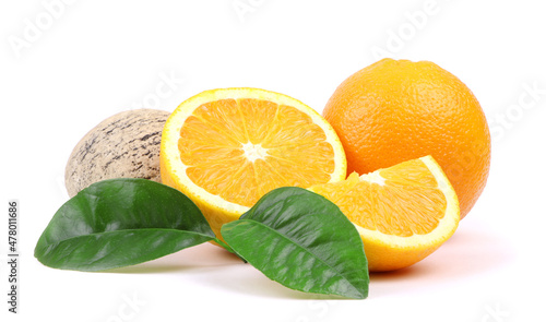 An orange isolated on a white background. Slice of orange fruit and green leaves