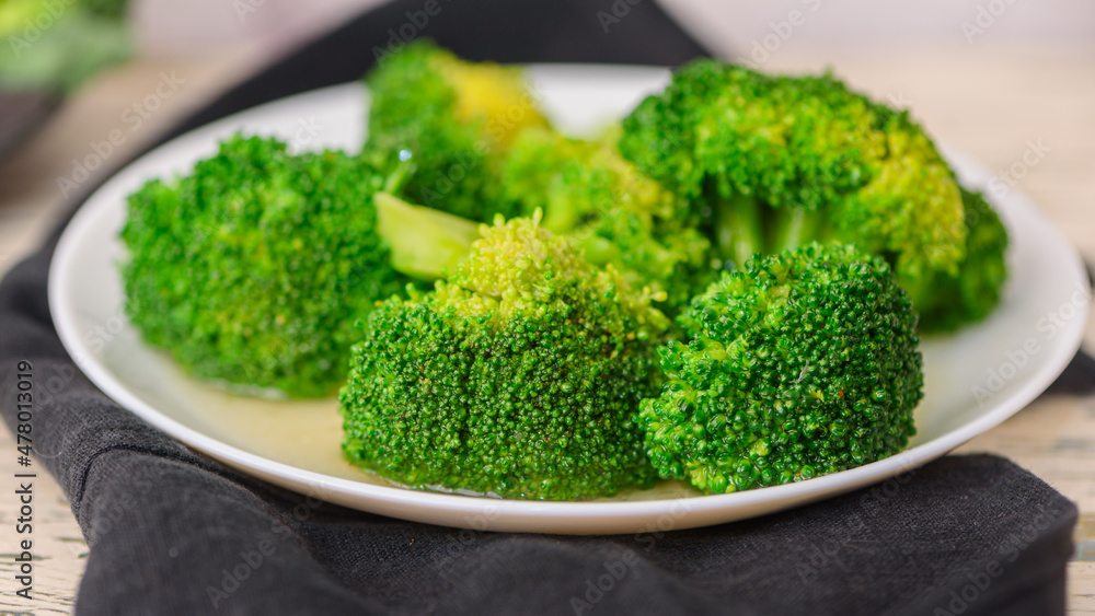 Fresh green broccoli on a light background. Macro photo green fresh vegetable broccoli. Fresh green broccoli on a light background. Macro photo green fresh vegetable broccoli.