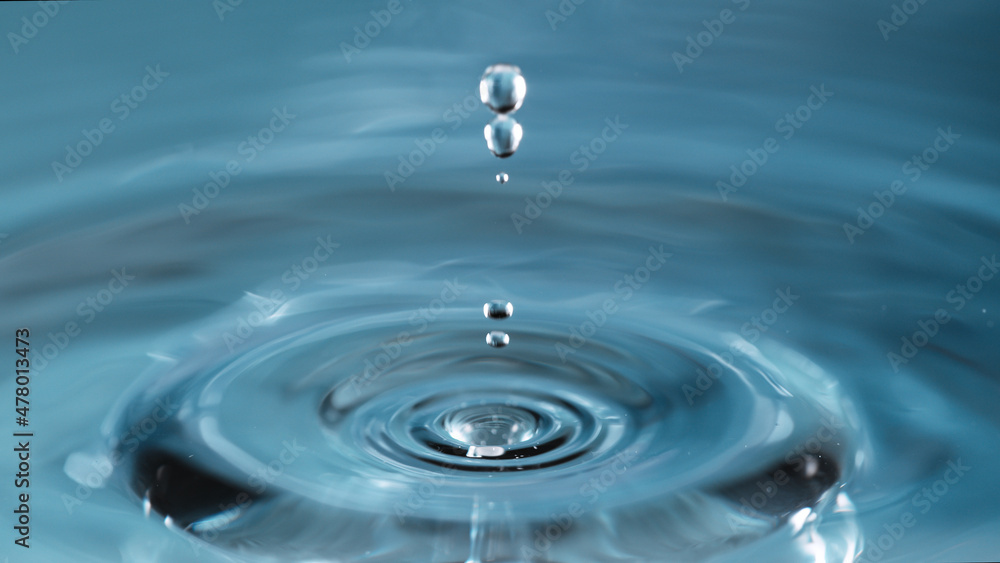 Water splash isolated on light blue background, macro shot. Water splash isolated on light blue background, macro shot.