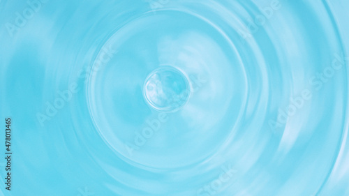 Water splash isolated on light blue background, macro shot.