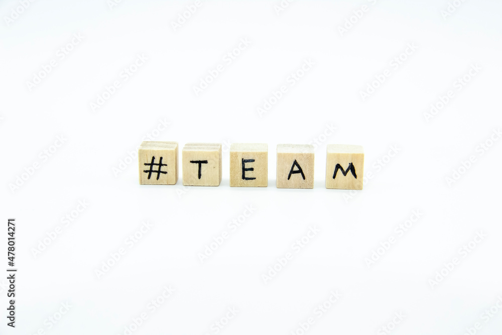 Word TEAM written on the wood cubes on white background. The concept photo with letters #team Word TEAM written on the wood cubes on white background. The concept photo with letters #team