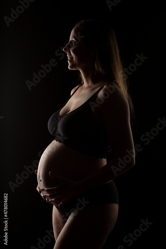 Normal pregnant woman with more than 35 years and 8 months of gestation. Black underwear. © angel