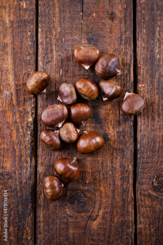 Edible chestnut on brown, top view