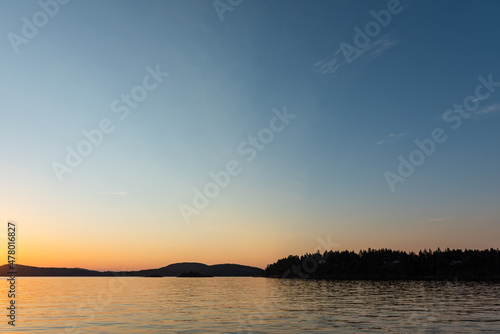 View from Saturna Island dock of silhouetted Southern Gulf Islands at sunset