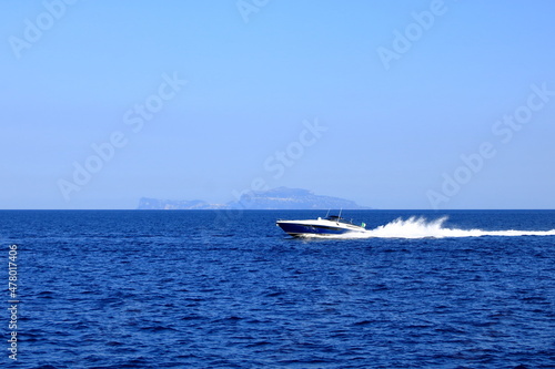 Silhouette of Capri island from a distance with famous Faraglioni rocks © Dynamoland