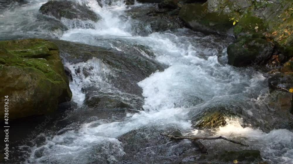 Mountain stream. water flowing between the stones. Slow motion HD Mountain stream. water flowing between the stones. Slow motion HD