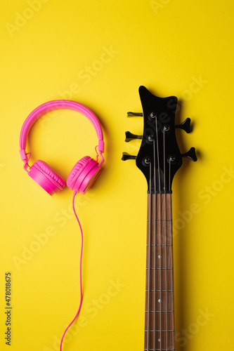 headband headphones fitted next to the head of a guitar