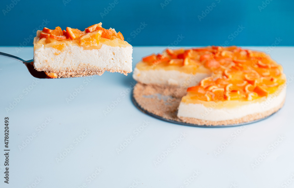 Closeup detail view sliced orange cheesecake or pudding, decorated with riped orange fruit. Closeup detail view sliced orange cheesecake or pudding, decorated with riped orange fruit.